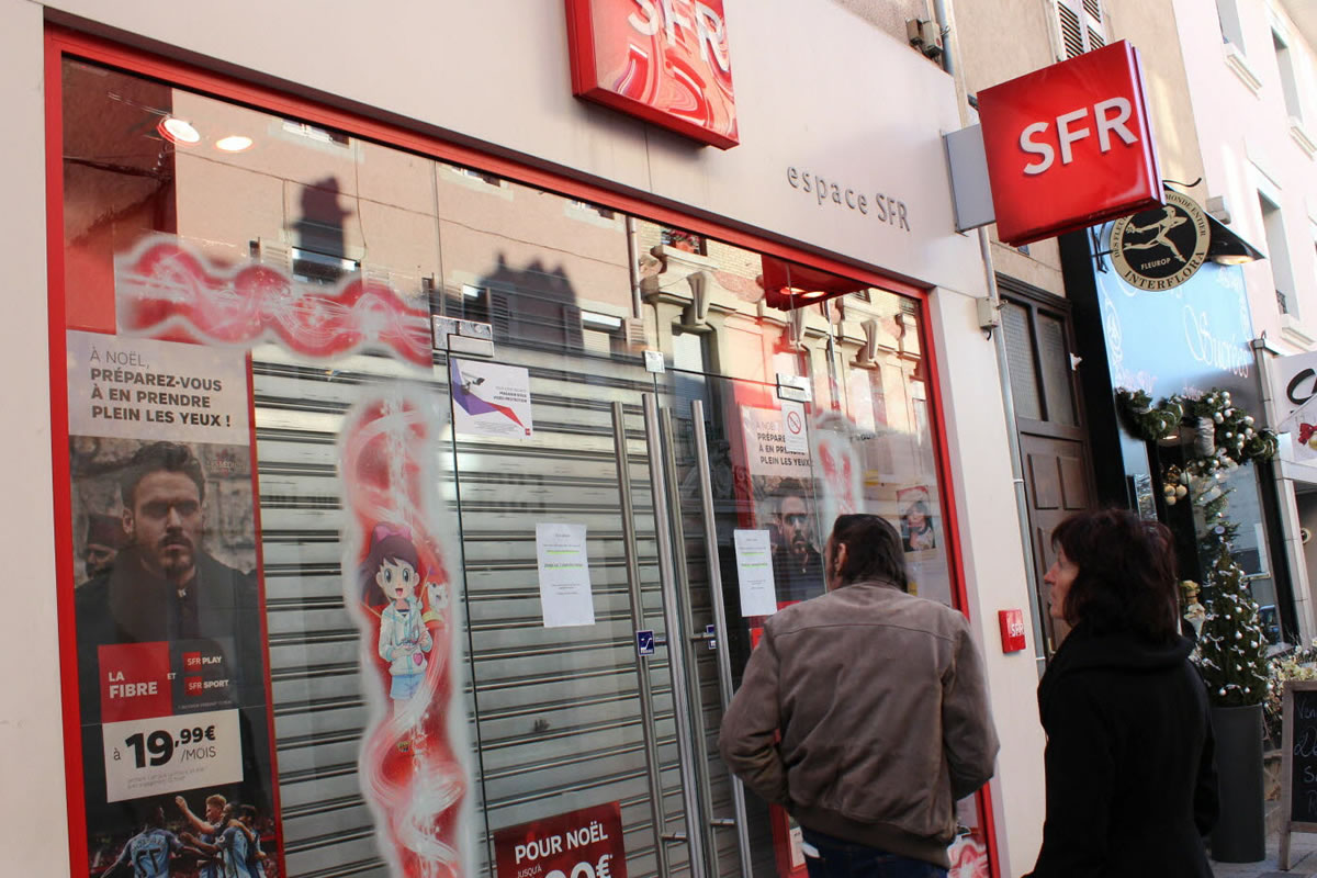 Photo d'une devanture de boutique SFR, avec son enseigne aux couleurs rouge et blanc