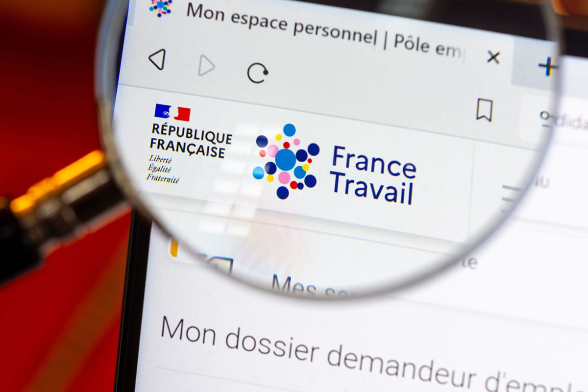 Photo d'une loupe placée au dessus d'une page du site internet de l'agence France Travail